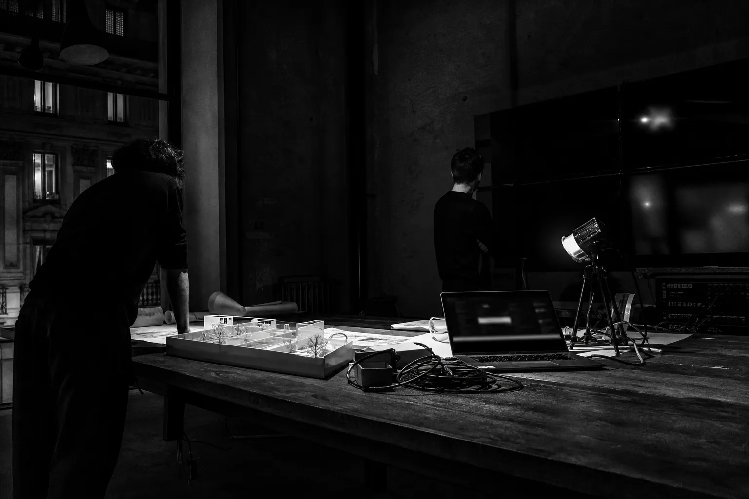 Black-and-white work table: mixed crafts, sketches and parts